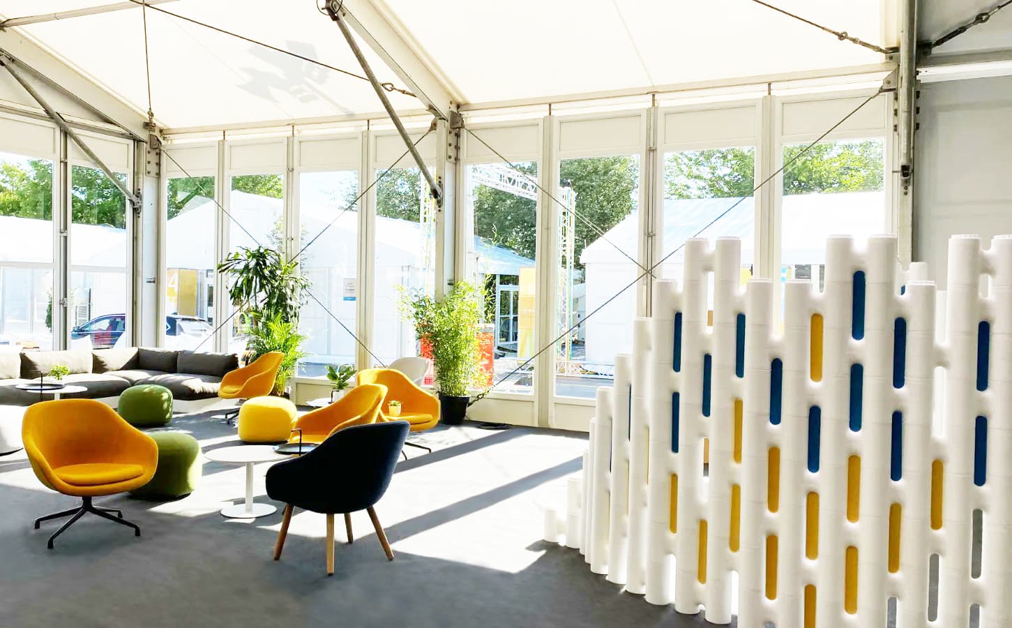 Modular partition wall with blue and yellow acoustic filler plates at Ecsite 2022