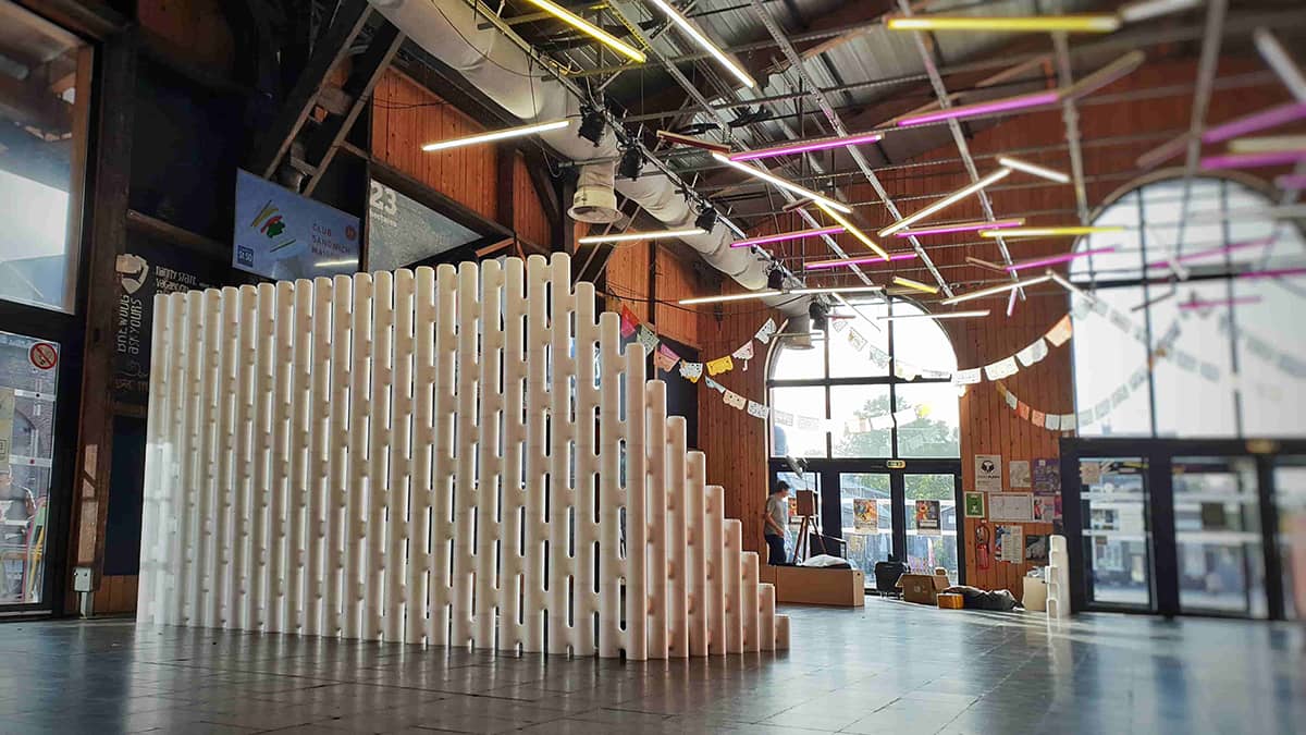 Tall stepped modular partition wall built from LINK units in an industrial event hall