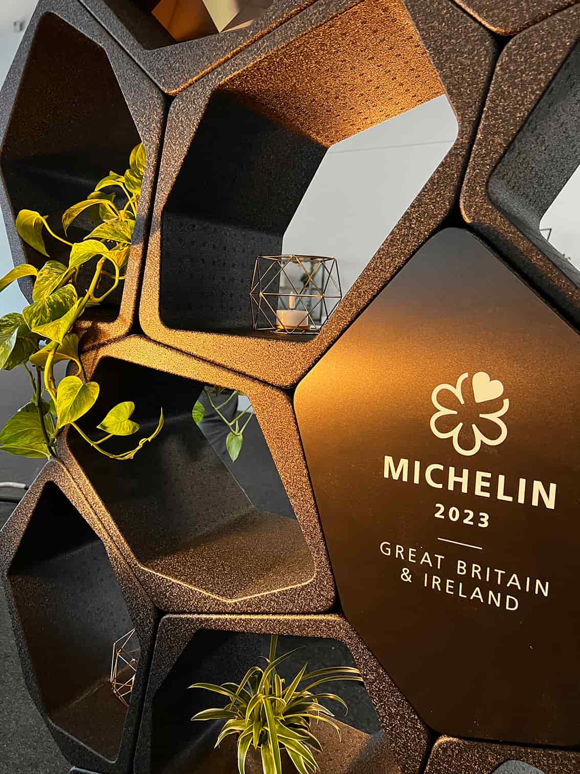 Black BUILD shelving units as room divider at the Rémy Martin booth, Michelin Awards Silverstone