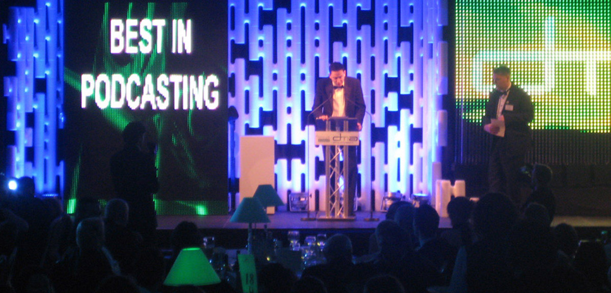 Illuminated modular partition wall used as a stage backdrop at an event