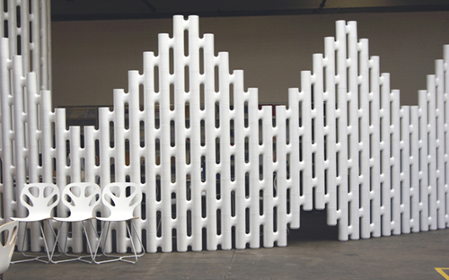 Stepped white freestanding partition wall with a doorway opening