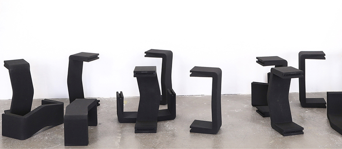 Row of black U-CUBE modules configured as shelves and seating