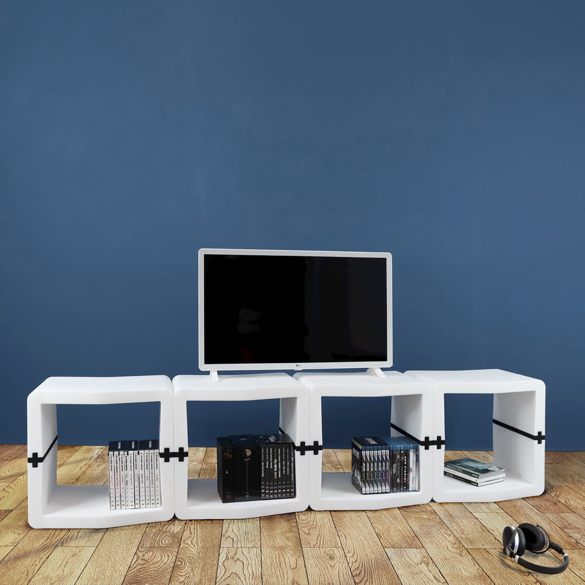 White U-CUBE TV lowboard of 16 modules against a blue wall