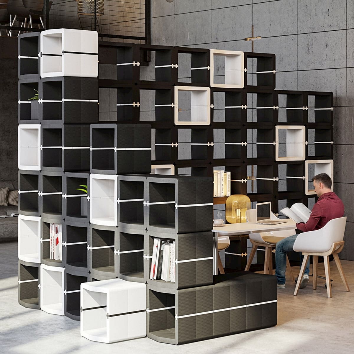 Black and white U-CUBE shelving wall with a desk area in an office