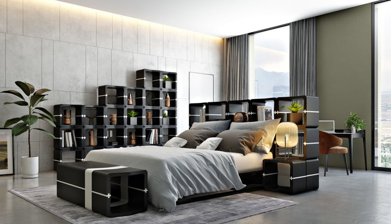 Black U-CUBE shelving partition separating the sleeping area in a bedroom